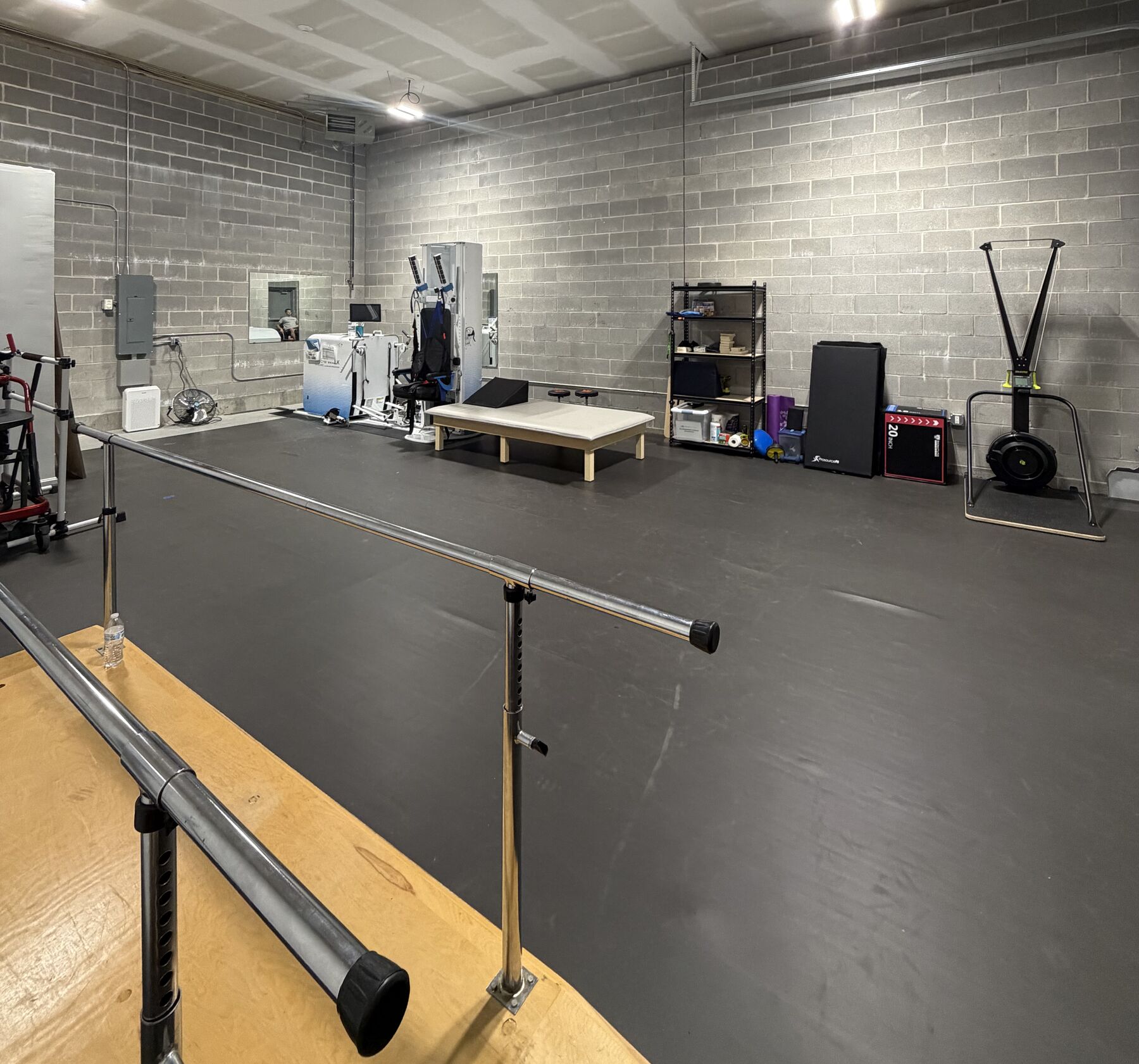 The STRIDE SCI gym space with parallel bars and adaptive training equipment
